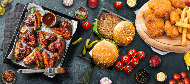 A spread of O'Snacks food — wings, burgers and fried chicken